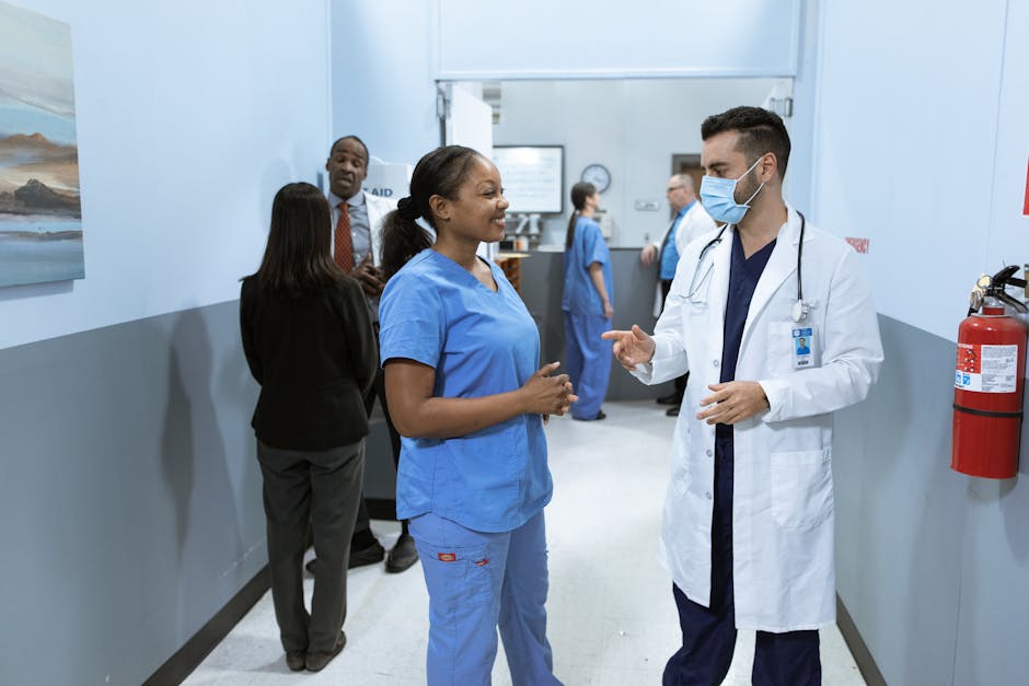Doctors and nurses in a hospital hallway discussing medical matters.